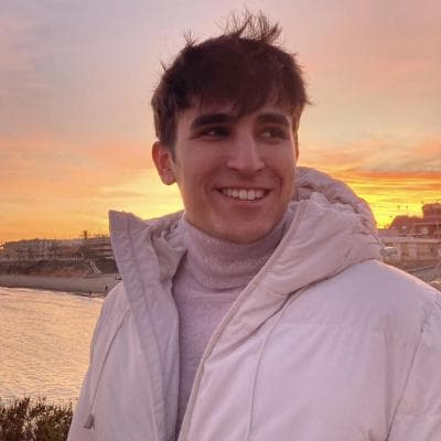Alberto Vegara smiling at sunset on the coast